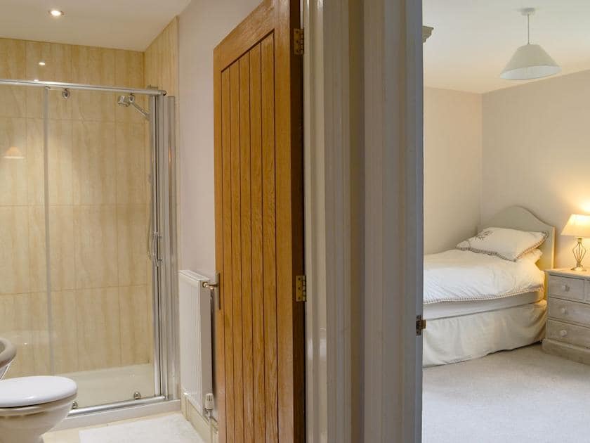 Twin bedroom leading through to shower room | Blackthorn Cottage, Norton Disney, near Newark