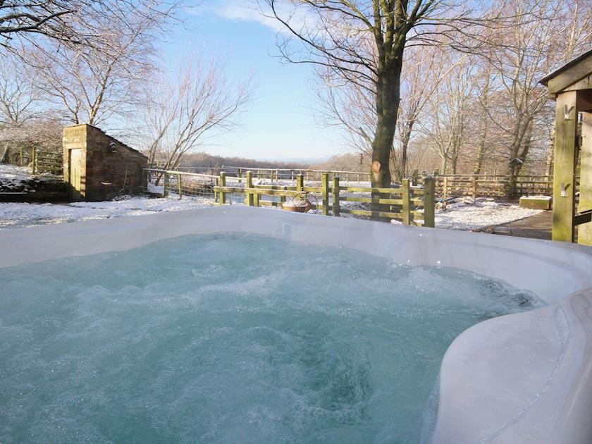 Views across the rolling lakeland countryside can be enjoyed from the hot tub | Woodpecker Cottage - Wallace Lane Farm Cottages, Brocklebank, near Caldbeck and Uldale