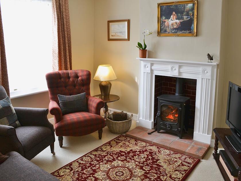 Living room with wood burning stove | Pippin Cottage, Holt