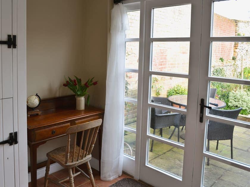 Patio doors leading to garden | Pippin Cottage, Holt