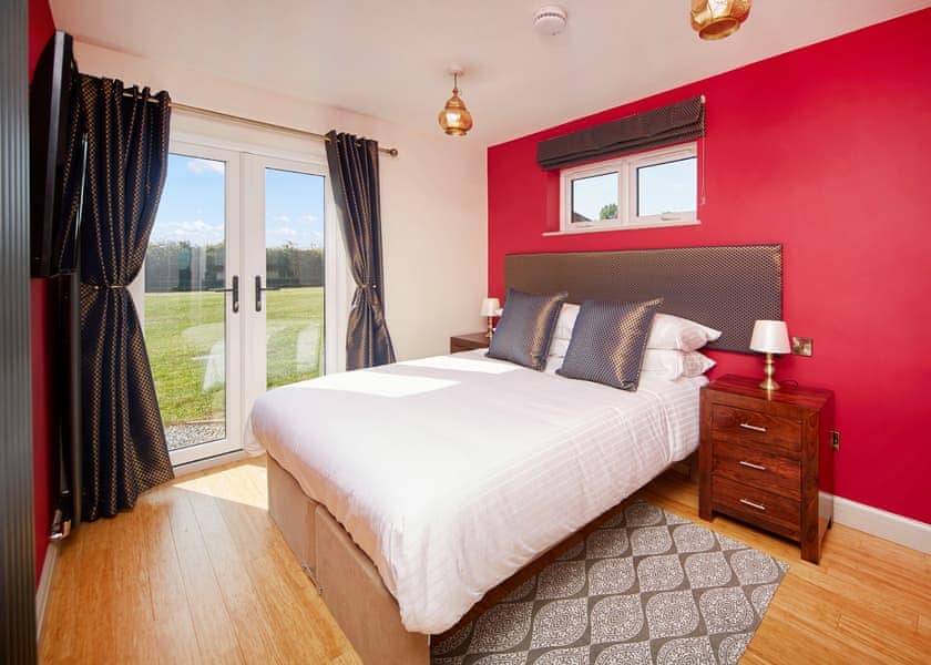 Attractive double bedroom with French doors to garden | The Kasbah - North Star Sanctum, Fitling, near Hornsea