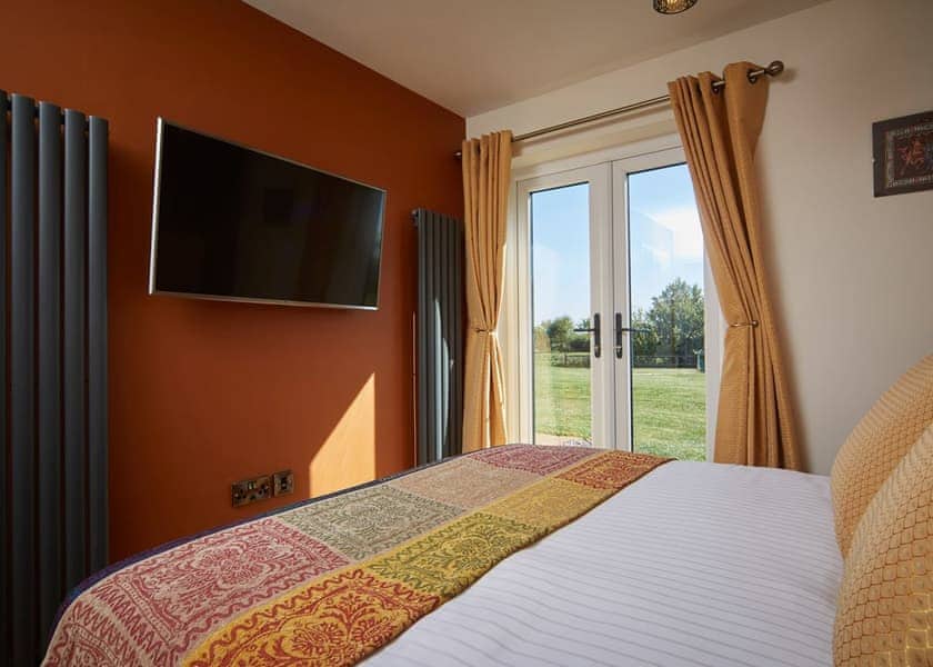 Stylish double bedroom with large wall mounted TV | The Raj - North Star Sanctum, Fitling, near Hornsea