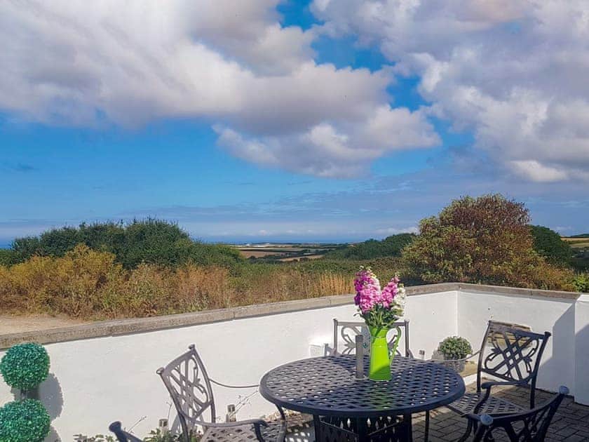 Patio with far reaching views | Trevone - Treginegar Cottages, St Merryn, near Padstow