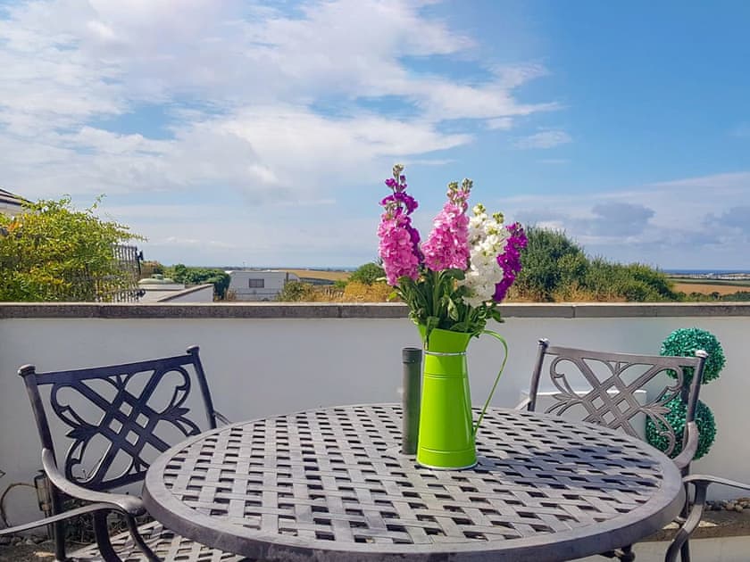 Patio with far reaching views | Trevone - Treginegar Cottages, St Merryn, near Padstow